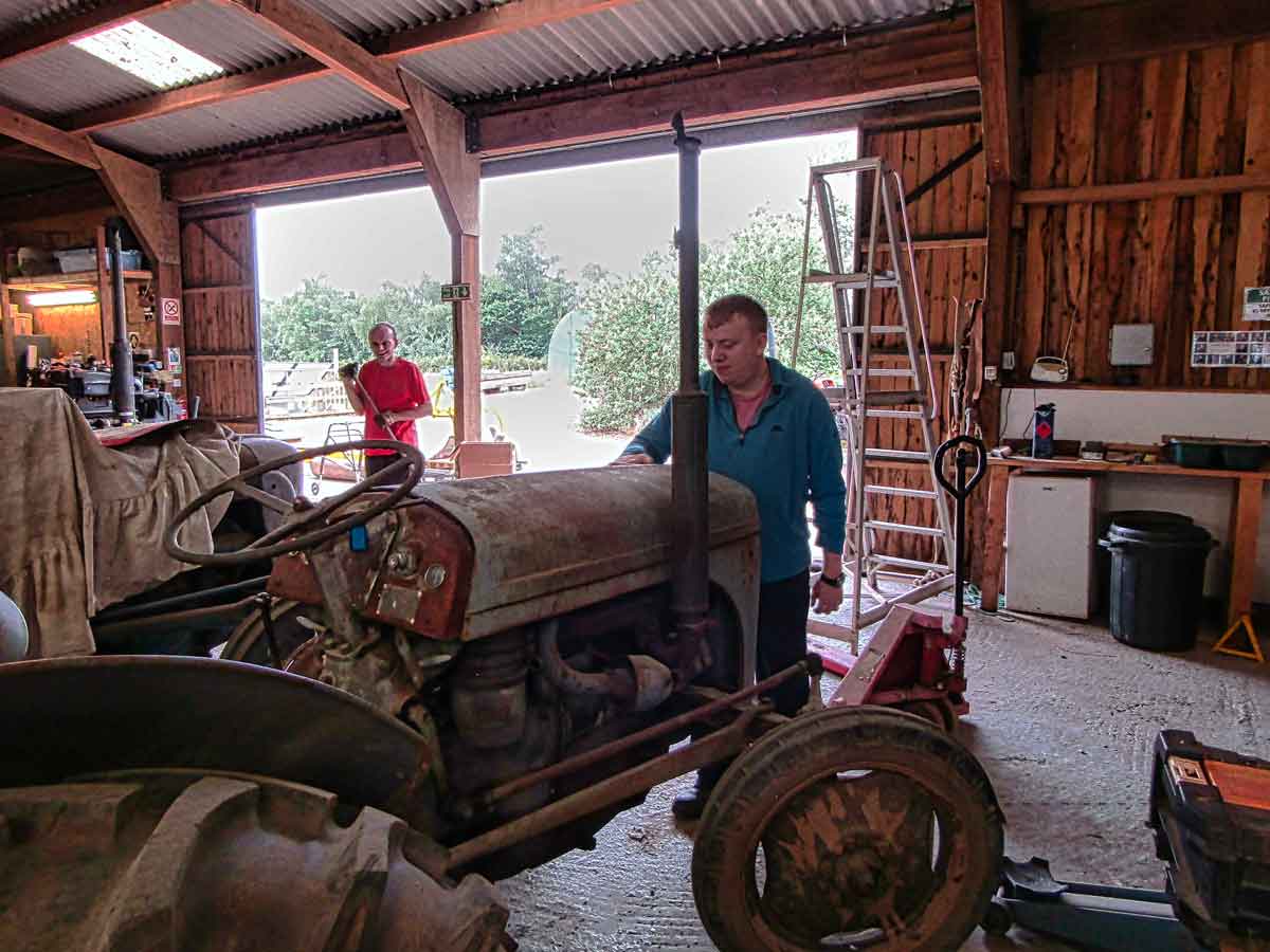 Sanding the vintage tractor at Dawlish Gardens Trust